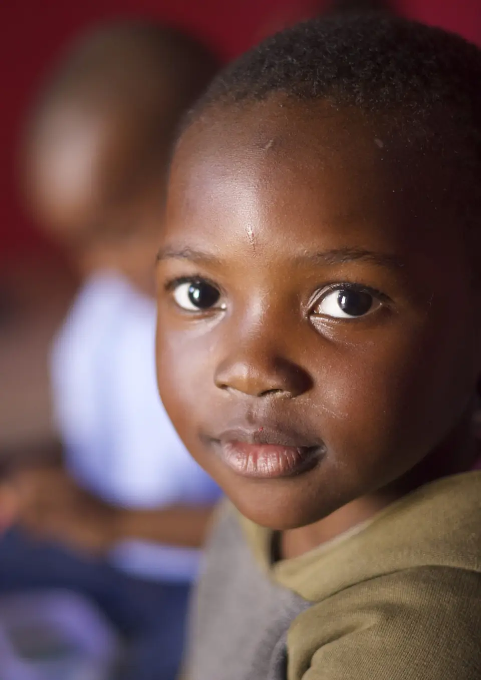 Close portrait of a young boy looking towards the camera.