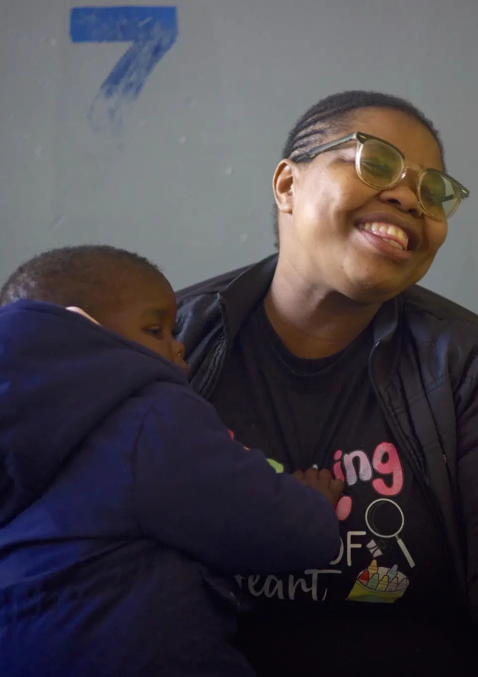 Practitioner Zoleka Mkhize with a young child at a day care centre.